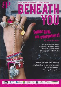 A poster from 'Beneath You'.  It shows a hand with lots of bracelets, rings and chains on.