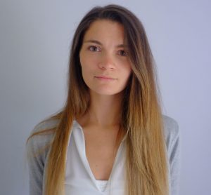 A photo of Amy Cheskin. She has very long brown hair that turns blonde near the ends and a heart shaped face.