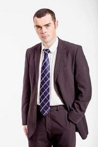A photo of Derek Darvell. He is wearing a smart suit and has short dark hair. 