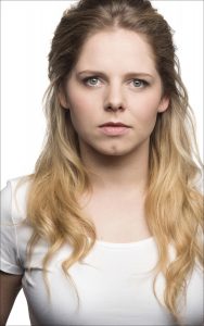 A photo of Dawn Sievewright. She has long blonde hair with brown roots and blue eyes