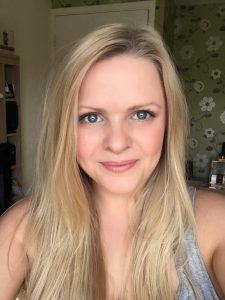 A photo of Nic Reilly. She has long blonde hair and big blue eyes. 