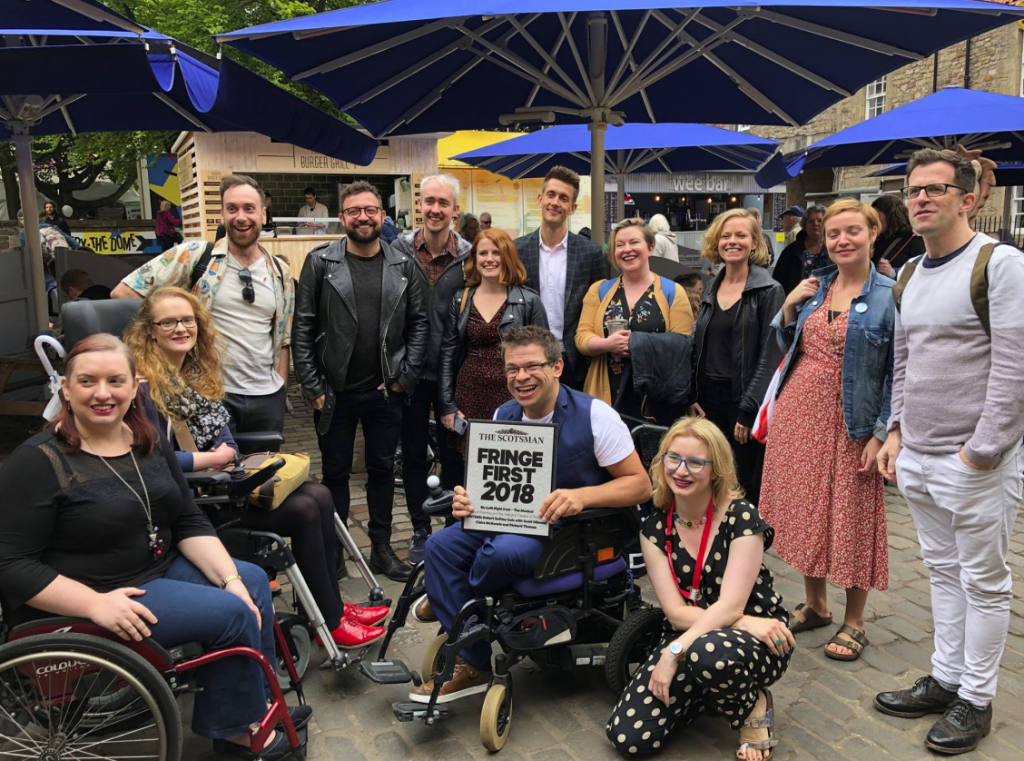 A cluster of the My Left / Right Foot team all pose for a photo, with Robert in the centre clutching onto the Fringe First award tightly.