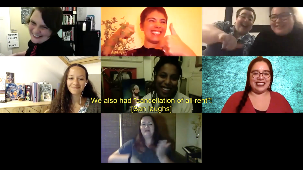 Still from ‘A Wake’ discussion hosted on Zoom, with eight people visible in seven squares. A yellow caption reads: "We also had 'cancellation of all rent! [San laughs]" Left-Right, Top Row: San Alland is white with short brown hair, they wear a black shirt and black and red striped tie, and they're laughing; Emilia Beatriz is Puerto Rican American with very short brown hair and a black top, they are sitting next to a plant and smiling large while giving a double thumbs-up. Elliot Webster-Mockett is a white person with very short brown hair, glasses and a septum piercing. He gestures excitedly to the camera while sitting next to a smiling Bea Webster, who is Scottish-Thai with straight shoulder-length dark hair, brown eyes and glasses. Left-Right, Middle Row: Jeda Pearl sits in front of a bookshelf wearing headphones and smiling, she has long, brown curly-frizzy hair, bronze-brown skin and brown eyes; Lake Montgomery is African-American with chest-length finger-thick dreadlocks, brown eyes and no makeup, she laughs in front of a portrait painting and a lit candle; Etzali is a nonbinary latinx femme, they have brown eyes, hoop nose piercings, long fluffy black hair and glasses, and sit smiling in front of a bright turquoise backdrop. Bottom Row: Yvonne Strain is a white woman with shoulder-length wavy brown hair, she is interpreting into British Sign Language.