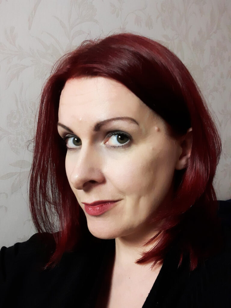 Head shot of Jen McGregor. She is a white woman in her 30s with shoulder length dark red hair.