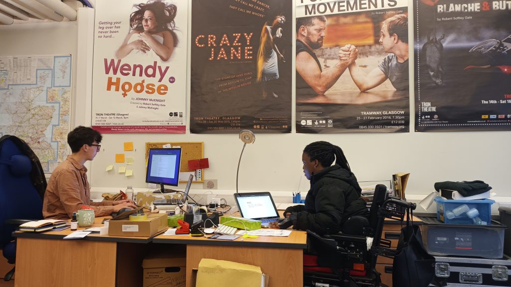 Cleopatra sitting at a desk in the BOP office.